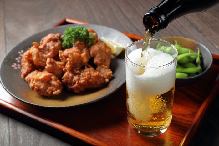 beer being poured to accompany karaage