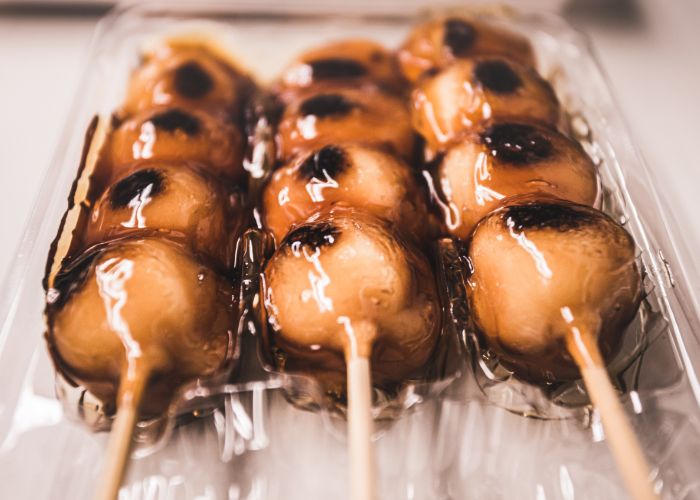 Four sticks of dango, sweet Japanese rice balls, covered in a sticky glaze