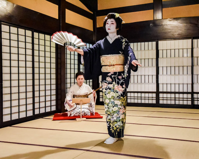 A geisha performs a dance during a special dinner in Odawara
