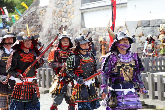 People dressed as samurai parade through Odawara in Japan