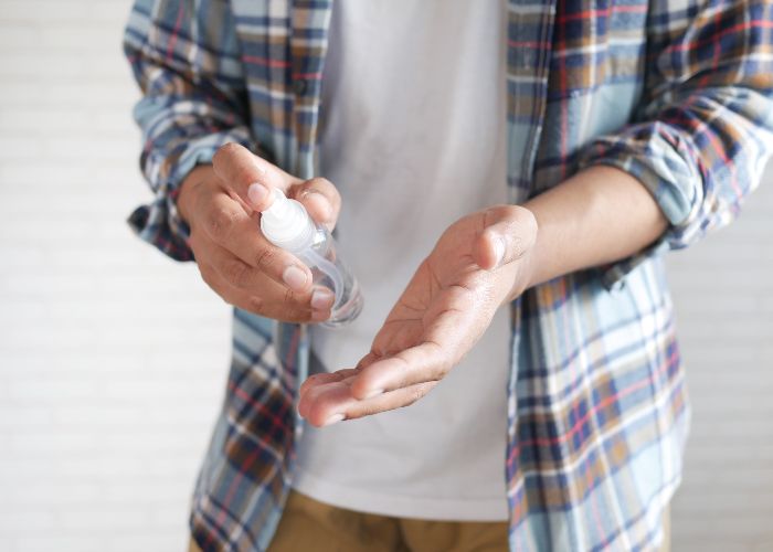 Man using hand sanitizer