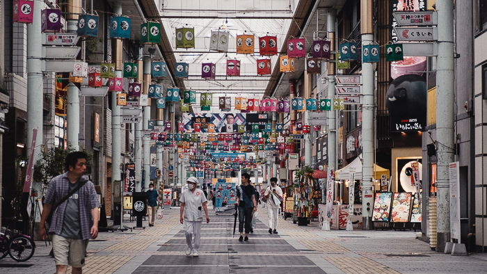 Covered arcade with colorful lanterns strung across the roof