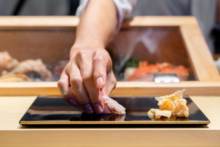 A chef prepares an omakase sushi platter in Japan