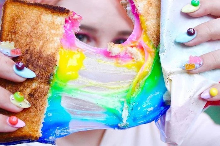 Rainbow Toast in Harajuku, held up by colorful manicured hands