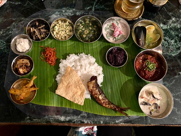 Traditional Indian banana leaf thali with diverse dishes