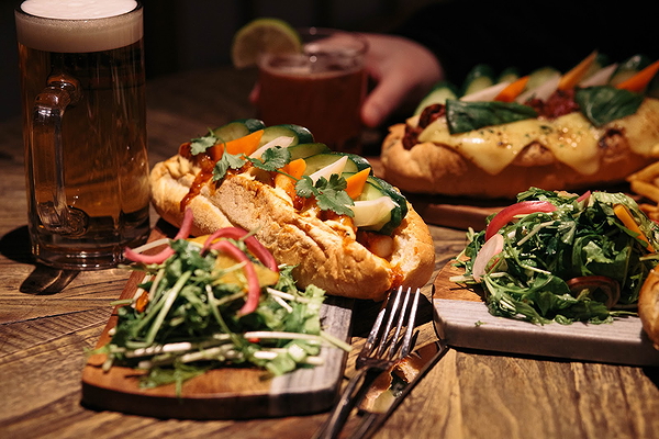 Gourmet sandwiches and salads on rustic table