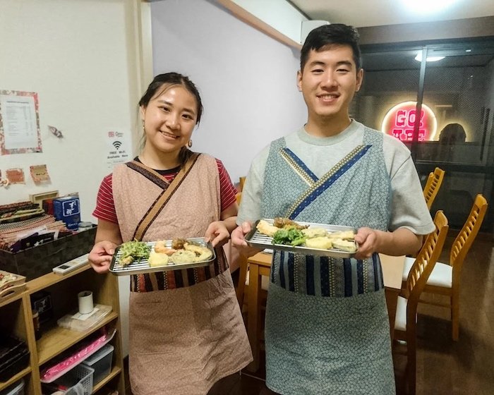Osaka Tempura Class participants hold out trays of tempura