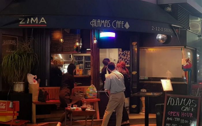 People stand outside a bar in Tokyo's 2-chome LGBTQ district