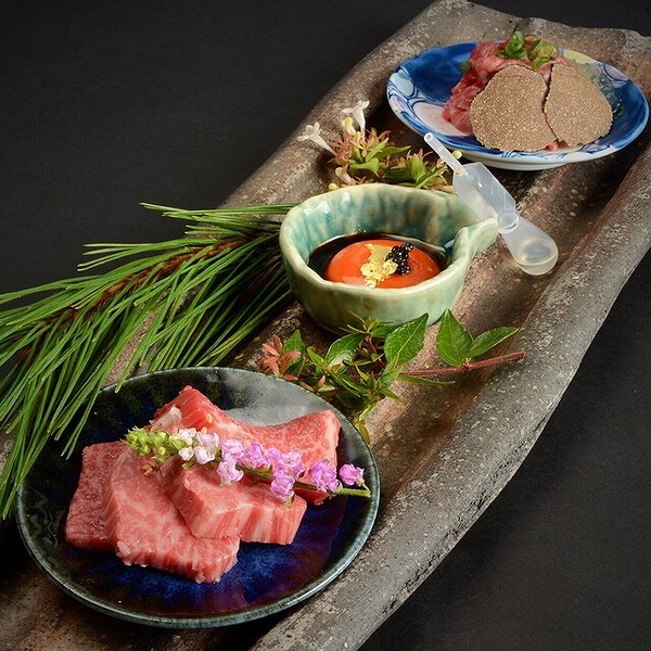 Elegant Japanese cuisine with sashimi and toppings on a ceramic platter