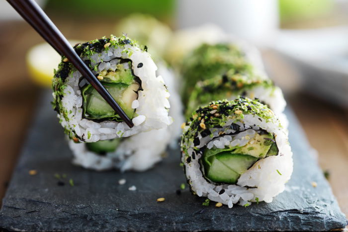 Veggie Sushi Rolls being picked up by chopsticks