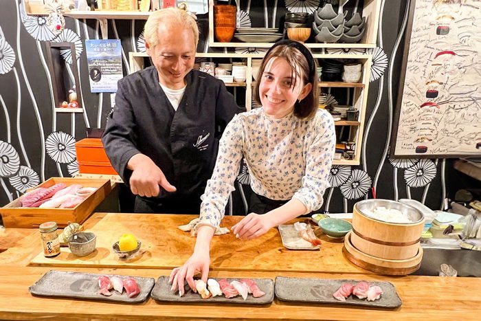 Chef Saisho shows a visitor how to prepare sushi