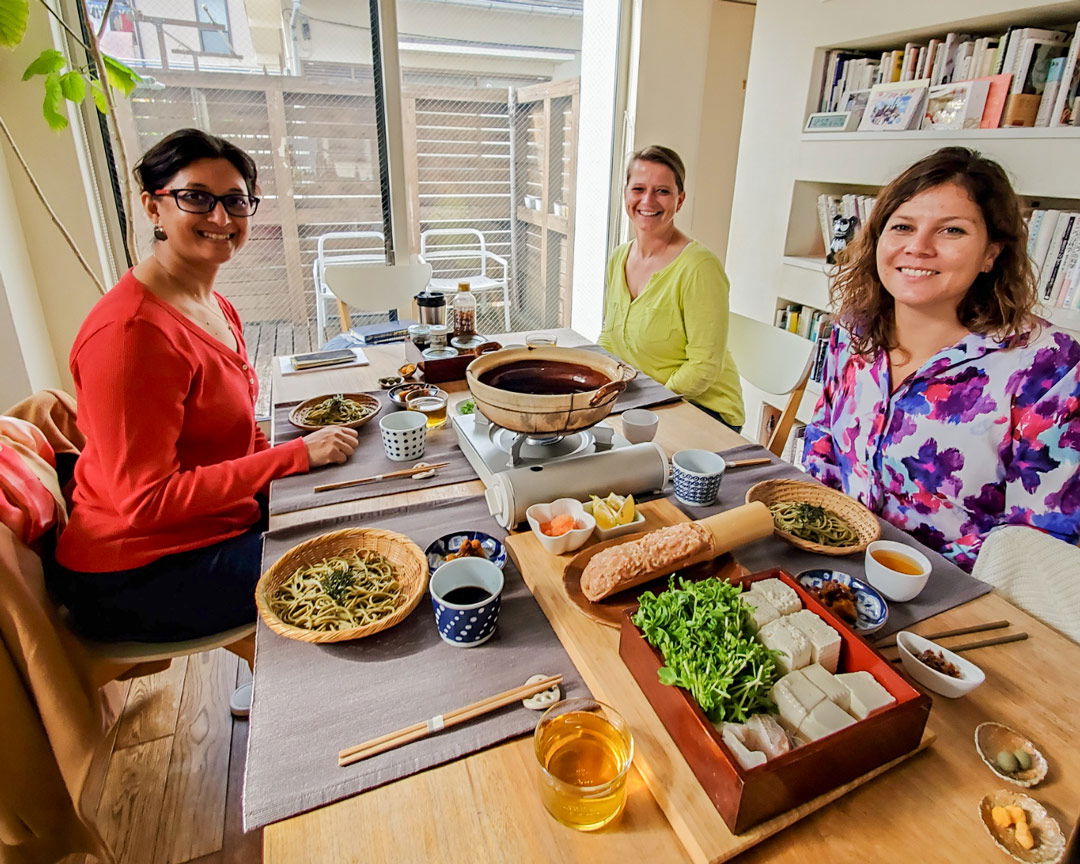 Three women sitting with their handmade toshikoshi soba at a cooking class in Japan
