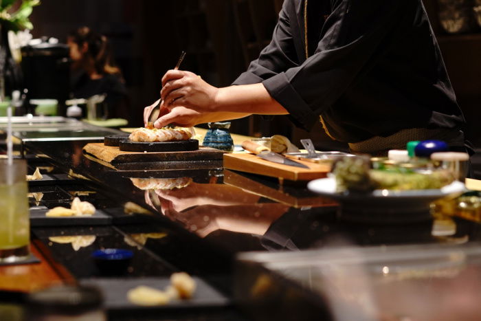 Chef preparing sushi at a modern Japanese restaurant