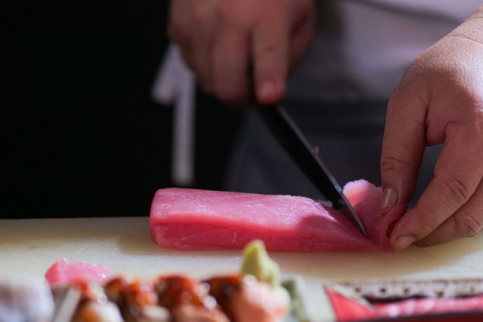 Close-up of a chef slicing sashimi