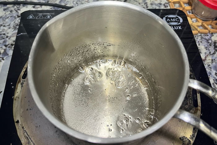 A pot of boiling water on a stove