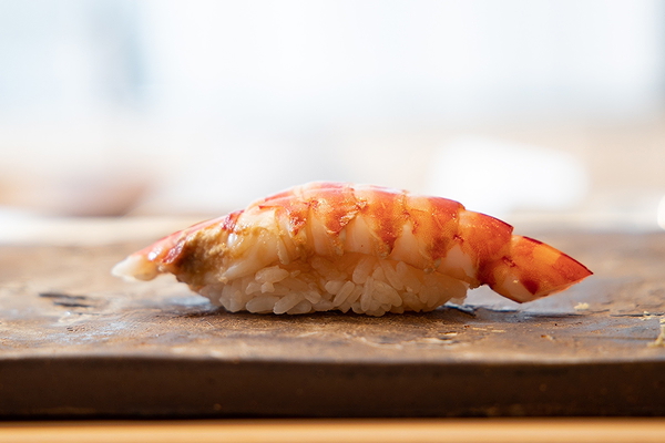 Exquisite sushi nigiri served on a stone platter in a stylish restaurant