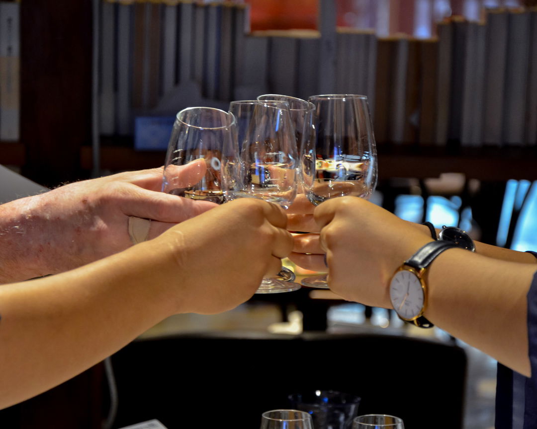 Guests raising a glass of sake at a sake tasting in Niigata’s oldest Shinto Shrine.