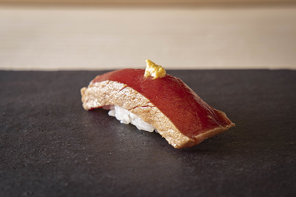 Exquisite sushi nigiri with fresh tuna on black slate