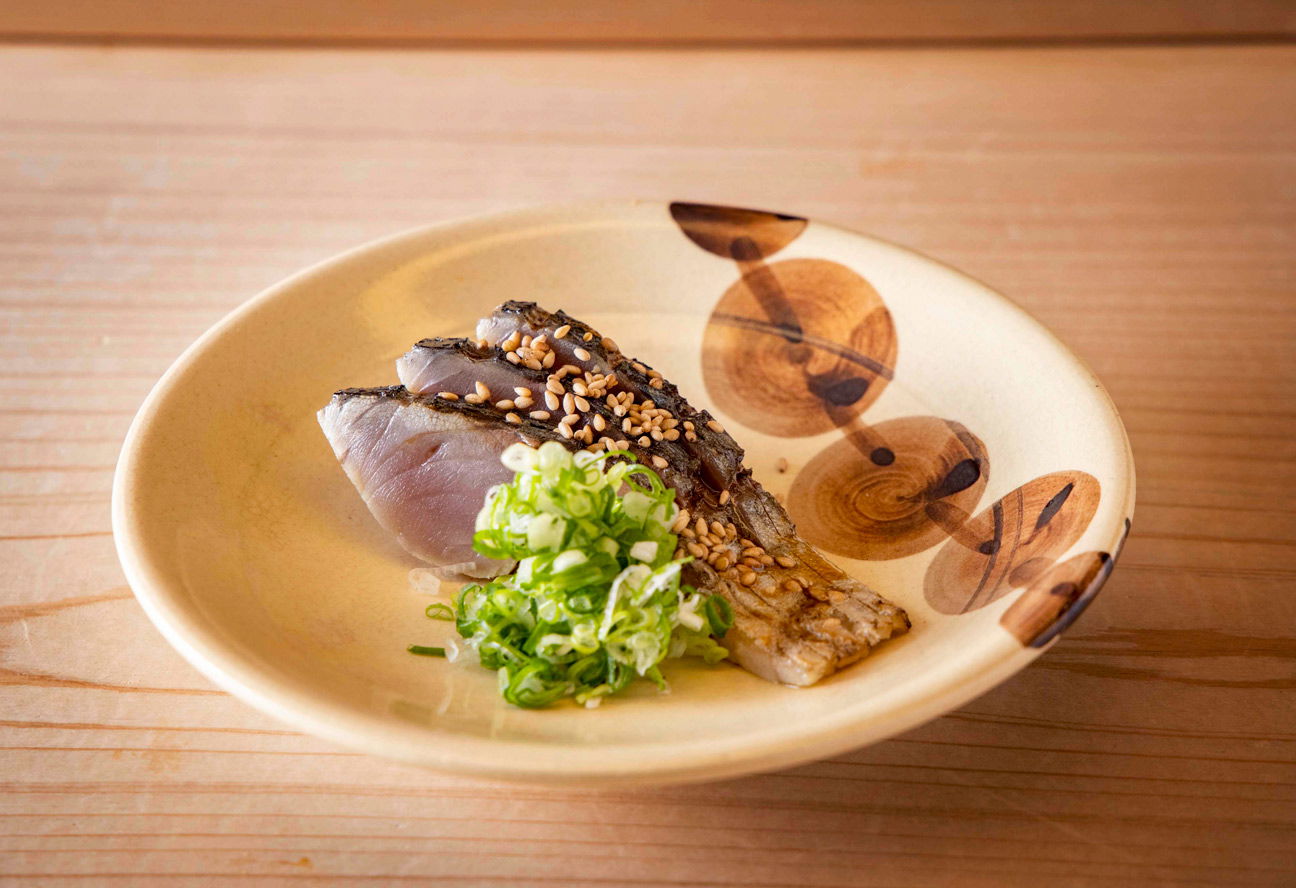 Delicate slices of fresh fish and spring onions at Sushi Gion Matsudaya.