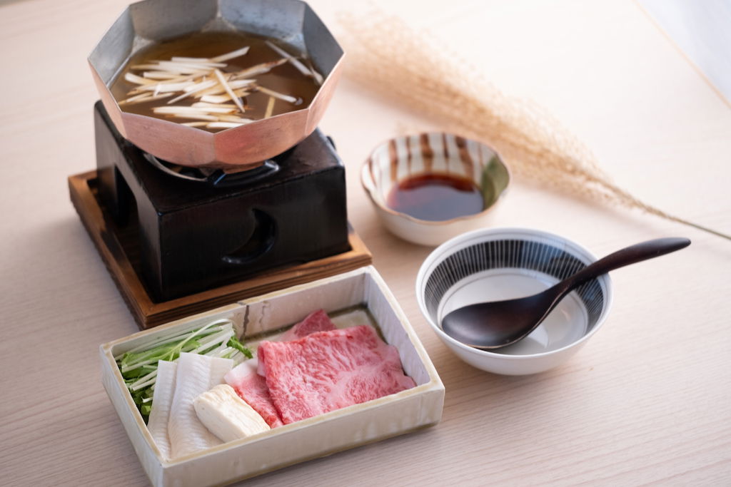 A selection of fresh ingredients, including wagyu beef, ready to be dunked in a nearby hot pot.