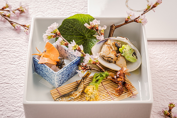 Exquisite Japanese culinary display with seafood and delicate garnishes