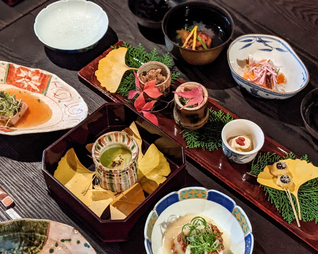 A table filled with seasonal dishes on this Matsumoto food tour.