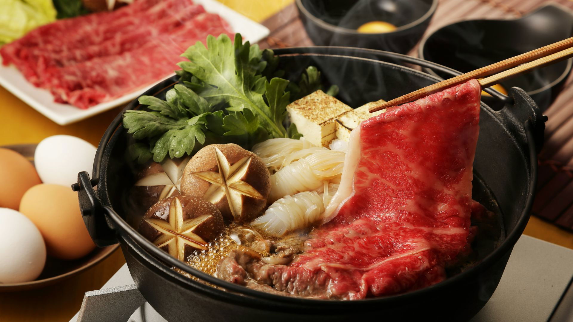 Traditional sukiyaki with beef, tofu, and vegetables in hot pot