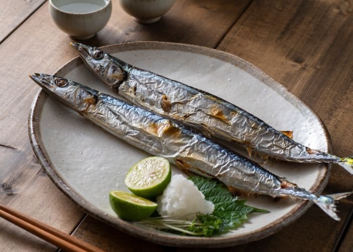 Grilled sanma (Pacific saury) served with lime, daikon and shiso.