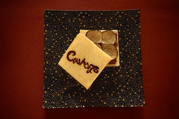 Gourmet dish with truffle and biscuit on elegant plate