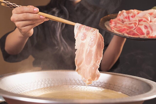 Authentic Asian hot pot cuisine with fresh sliced meat