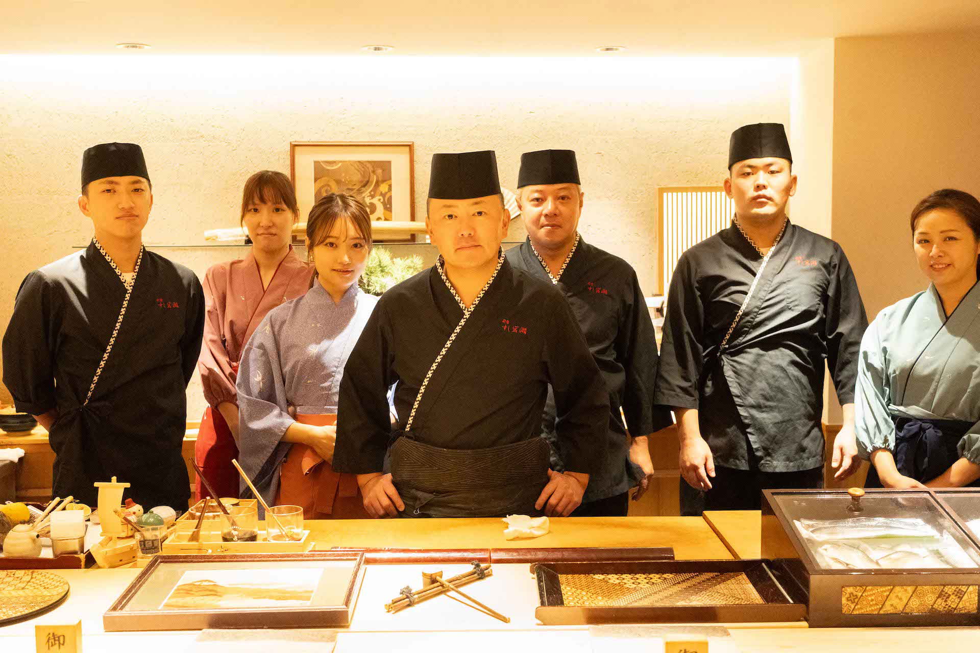 The chefs and staff of Sushi Iwase standing behind the counter