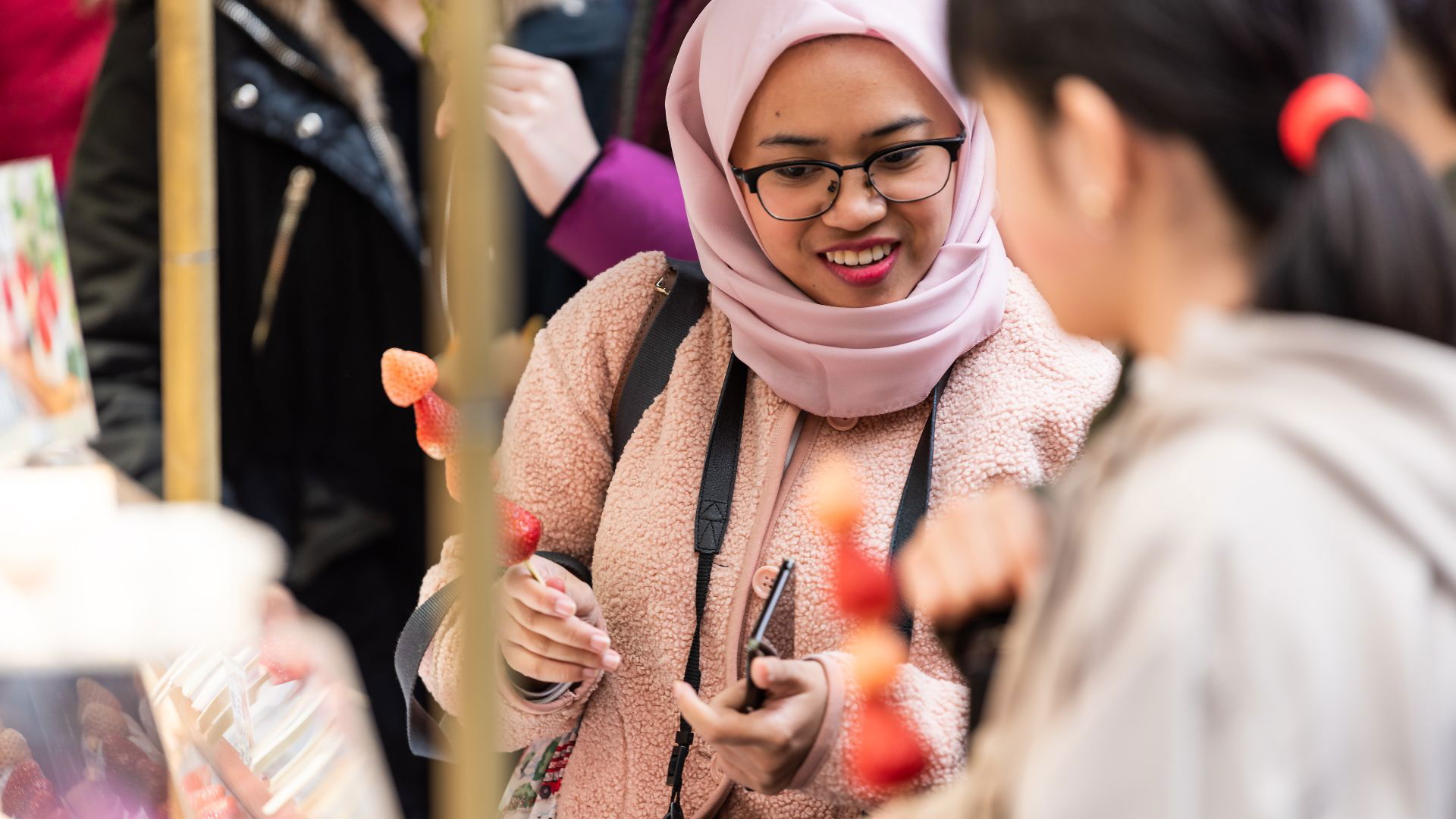 Woman enjoying a street food market with friends