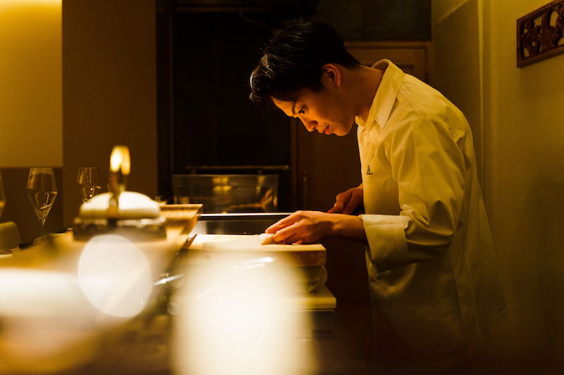  Chef Fujii hard at work, delicately slicing through fresh fish.