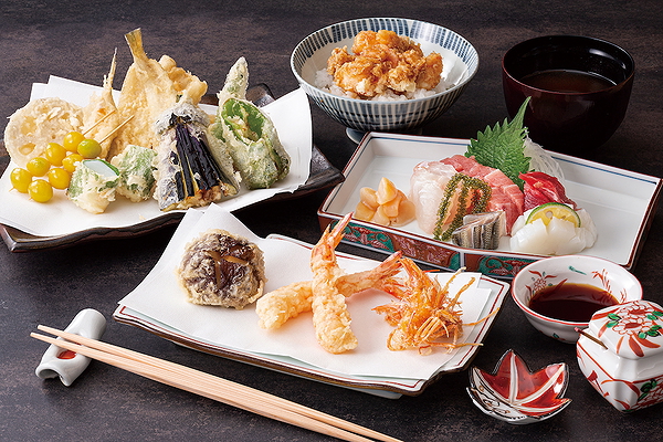 Assorted Japanese tempura and sushi platter with dipping sauces