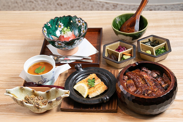 Traditional Japanese meal with grilled eel and side dishes