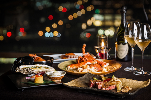 Gourmet dining setup with lobster and wine