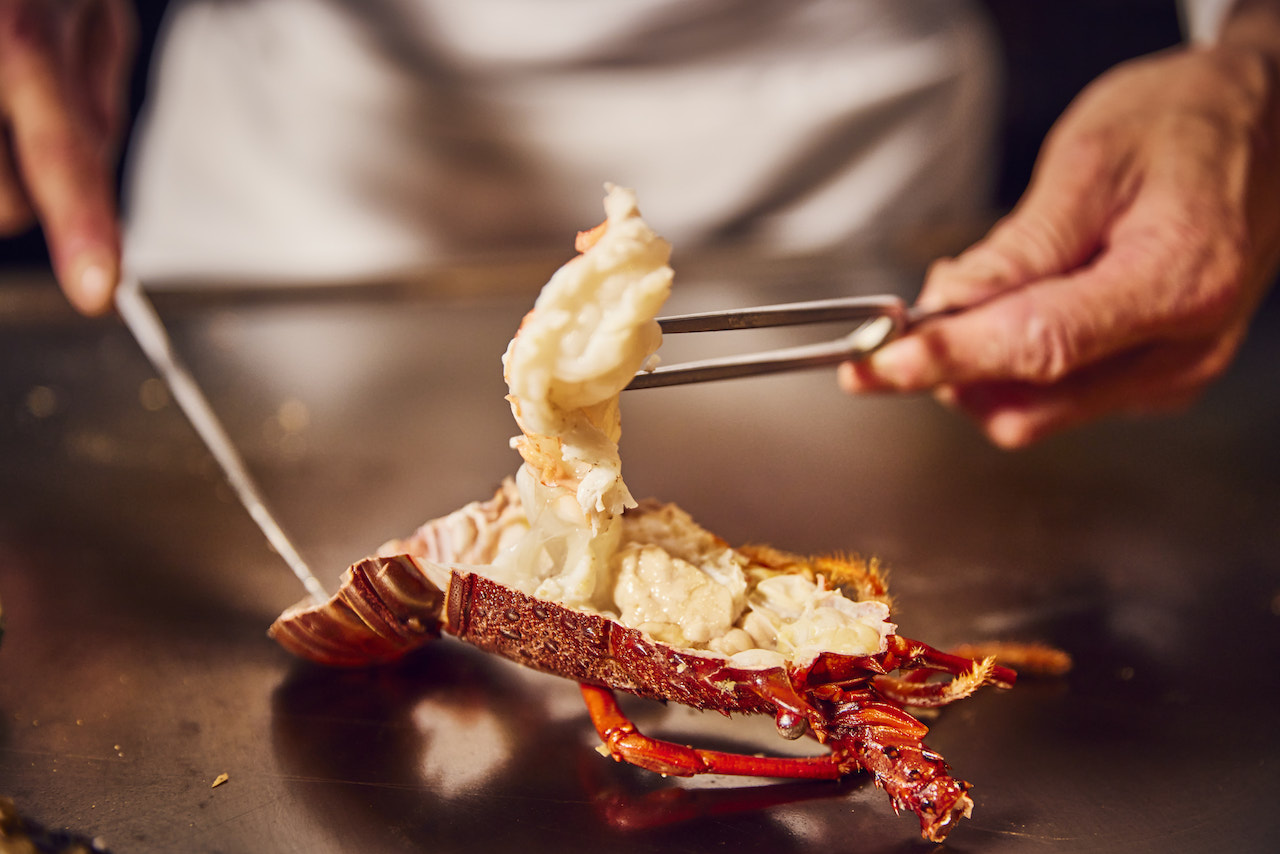 A luxurious serving of lobster being prepared at atelier Morimoto XEX.