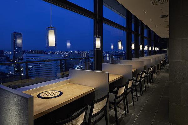 Elegant restaurant interior with panoramic city view at night