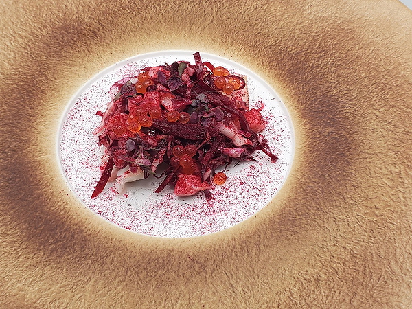 Gourmet beet salad with roe and microgreens on elegant plate