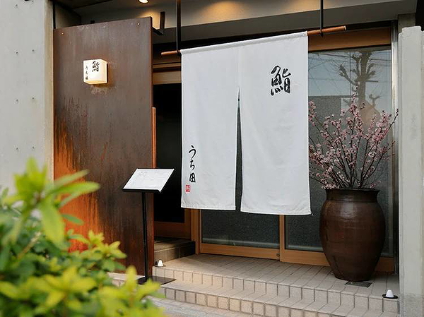 Charming restaurant entrance with elegant fabric curtains