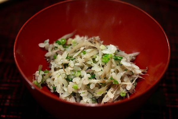 Herb-infused rice salad in a vibrant red bowl