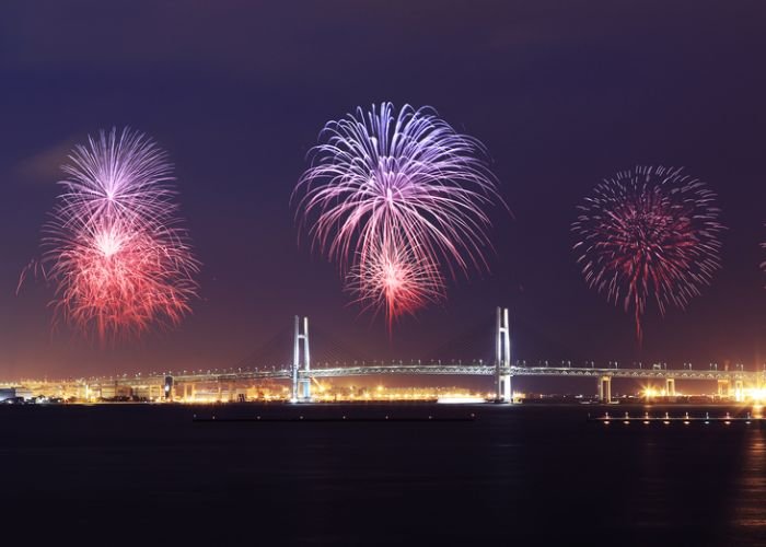 A photo of fireworks lighting up Yokohama Bay