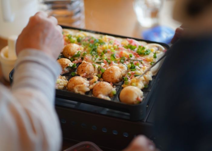 A pan of homemade takoyaki