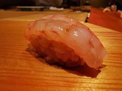 Fresh shrimp sushi on wooden table at upscale restaurant