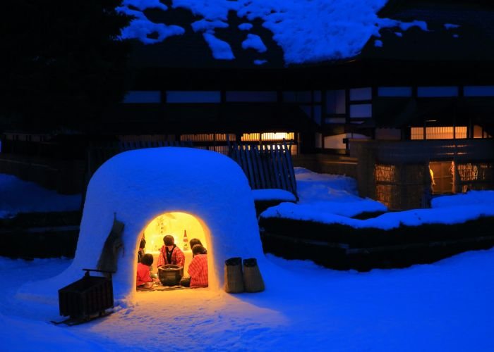 People having dinner in a kamakura snow dome in Akita