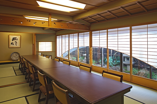 Elegant Japanese dining room with traditional tatami, wooden table, and shoji windows