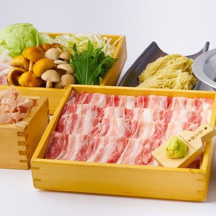 Japanese cuisine with fresh vegetables, shabu-shabu beef, and noodles
