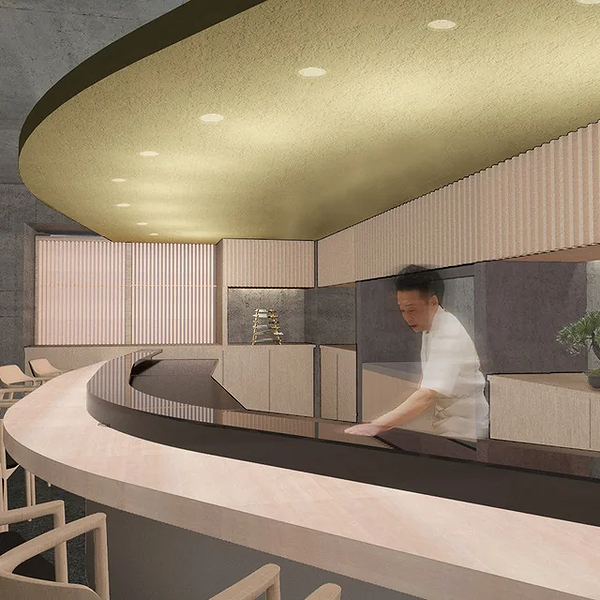 Modern restaurant interior with sleek counter and chef in action
