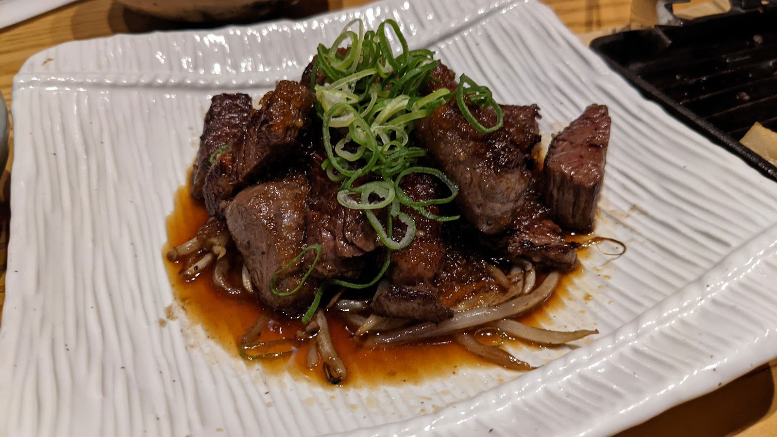 A saucy heap of wagyu beef garnished with spring onions at Tennosachi Yamanosachi.