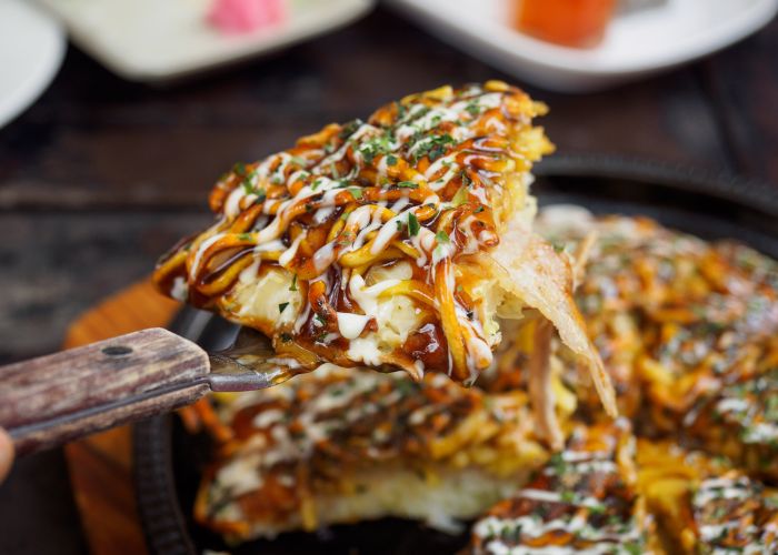 A close up of a piece of okonomiyaki